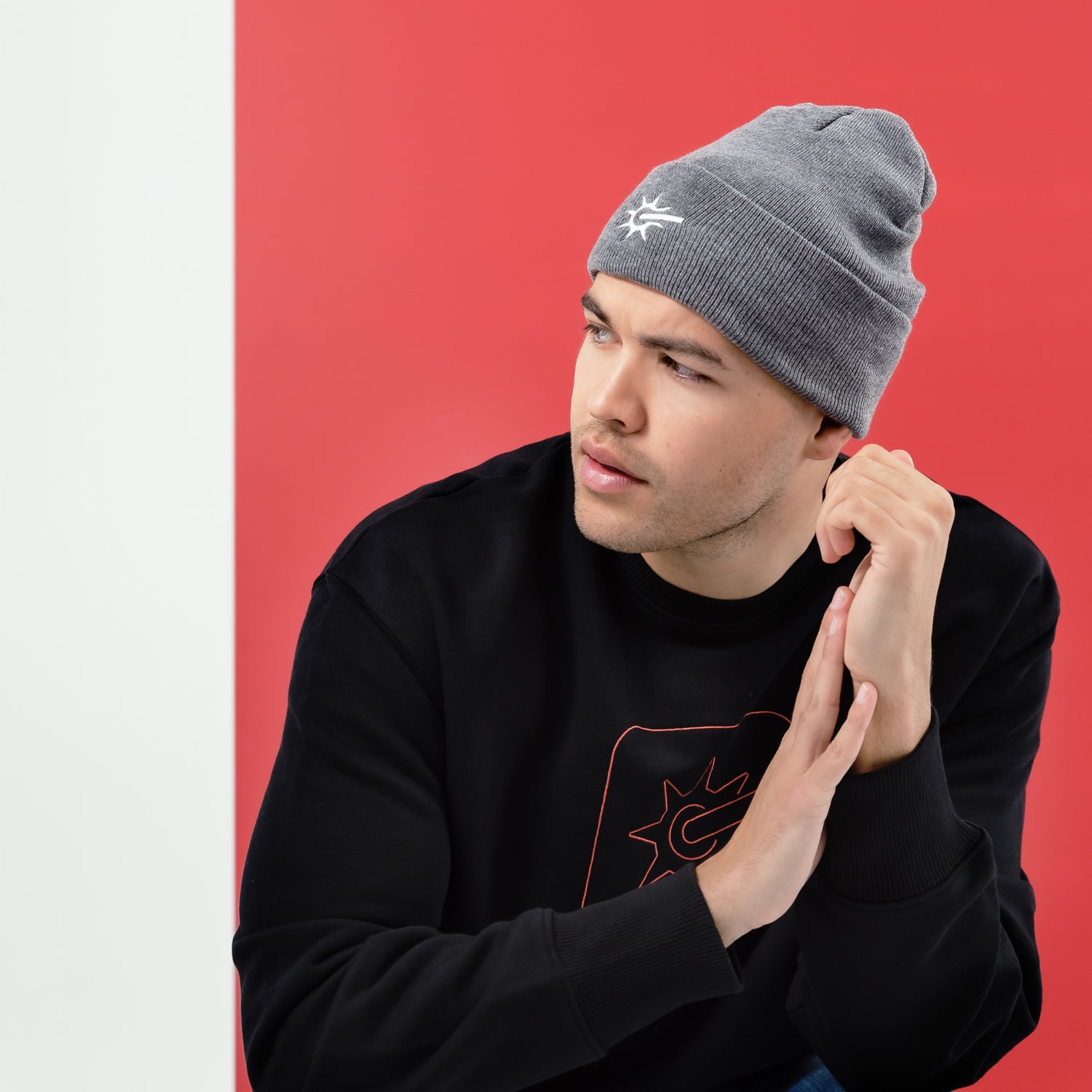 White male model wearing a gray beanie and a black sweatshirt by Rodeo.